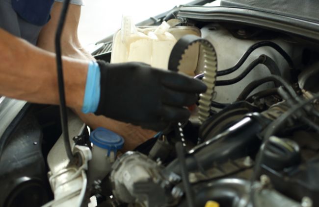 Mechanic holding a timing belt during a mobile car belt replacement in Sydney by True Blue Mobile Mechanics. Mechanic holding a timing belt during a mobile car belt replacement in Sydney by True Blue Mobile Mechanics.