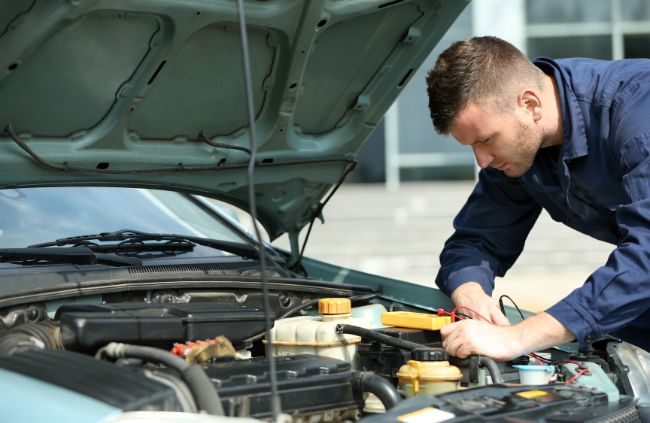 True Blue Mobile Mechanics technician performing starter motor repair in Sydney under the bonnet of a vehicle. True Blue Mobile Mechanics technician performing starter motor repair in Sydney under the bonnet of a vehicle.