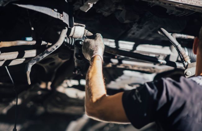 Suspension mechanic from True Blue Mobile Mechanics working on a vehicle’s undercarriage, repairing suspension components for safe and reliable handling in Melbourne. Suspension mechanic from True Blue Mobile Mechanics working on a vehicle’s undercarriage, repairing suspension components for safe and reliable handling in Melbourne.