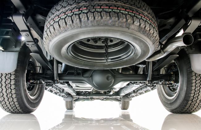 Underside view of a vehicle showcasing the car suspension system being inspected by True Blue Mobile Mechanics during a suspension service in Melbourne. Underside view of a vehicle showcasing the car suspension system being inspected by True Blue Mobile Mechanics during a suspension service in Melbourne.
